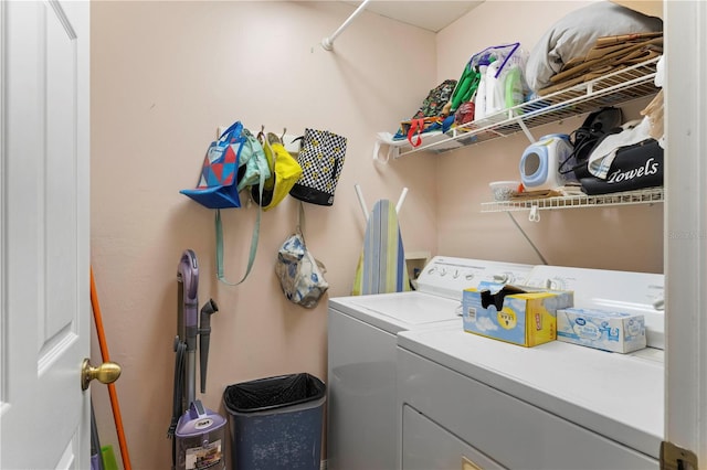 clothes washing area with washing machine and dryer