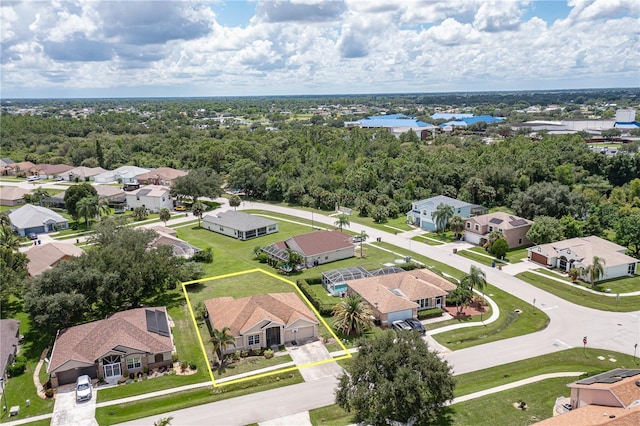 birds eye view of property featuring a forest view and a residential view