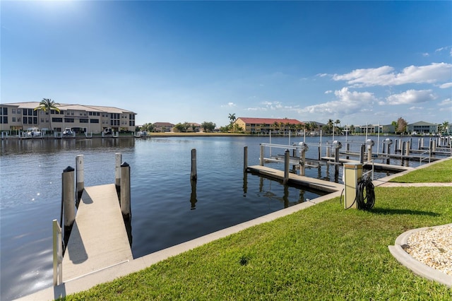 view of dock featuring a water view and a lawn