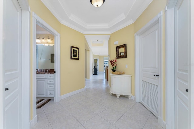 hallway with crown molding and light tile patterned flooring