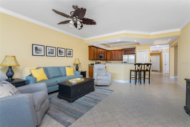 tiled living room featuring ceiling fan, a raised ceiling, and crown molding