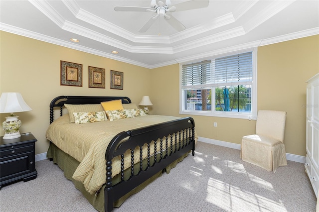 bedroom featuring ornamental molding, light colored carpet, ceiling fan, and a raised ceiling