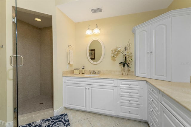 bathroom featuring vanity, an enclosed shower, and tile patterned flooring