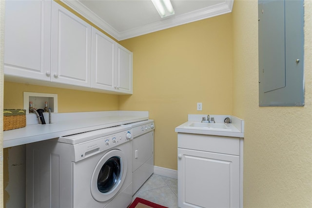 laundry area featuring cabinets, ornamental molding, washer and dryer, sink, and light tile patterned flooring