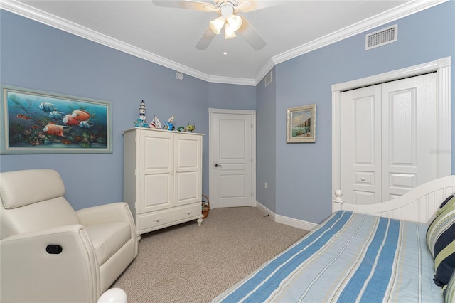 carpeted bedroom featuring a closet, ceiling fan, and crown molding