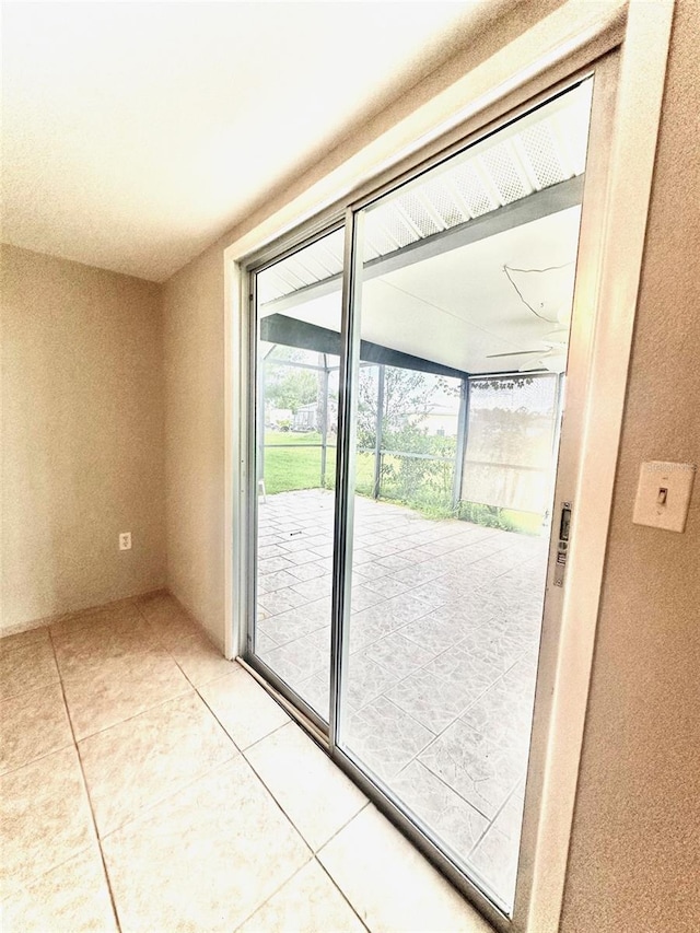 doorway featuring light tile patterned flooring