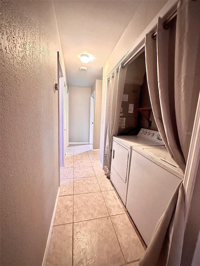 laundry area featuring washer / dryer, light tile patterned floors, baseboards, and laundry area