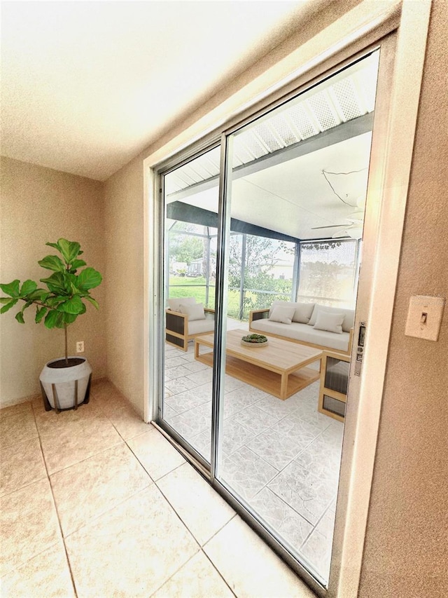 entryway with light tile patterned floors and a sunroom