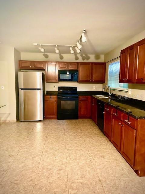 kitchen with a sink and black appliances