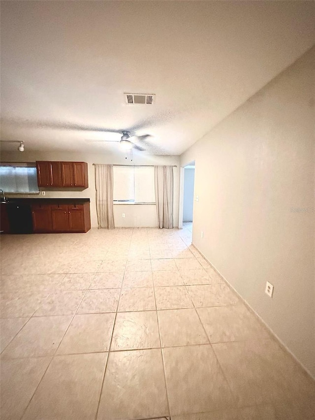 unfurnished living room with light tile patterned flooring, visible vents, and a ceiling fan