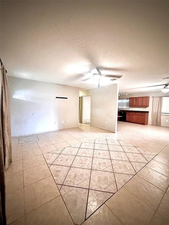 unfurnished living room with a textured ceiling and ceiling fan