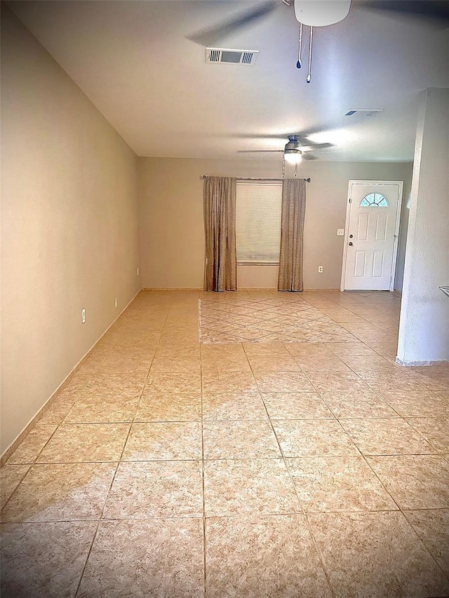 empty room with visible vents and a ceiling fan