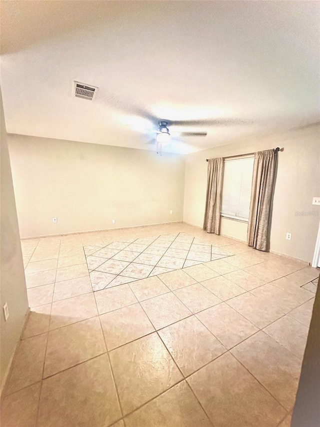 empty room with visible vents, ceiling fan, and light tile patterned flooring