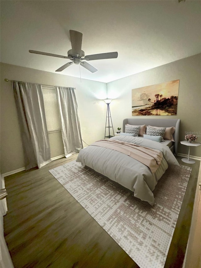 bedroom featuring wood finished floors, baseboards, and ceiling fan