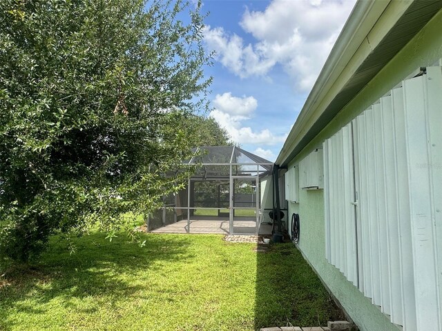 view of yard with a lanai and a patio