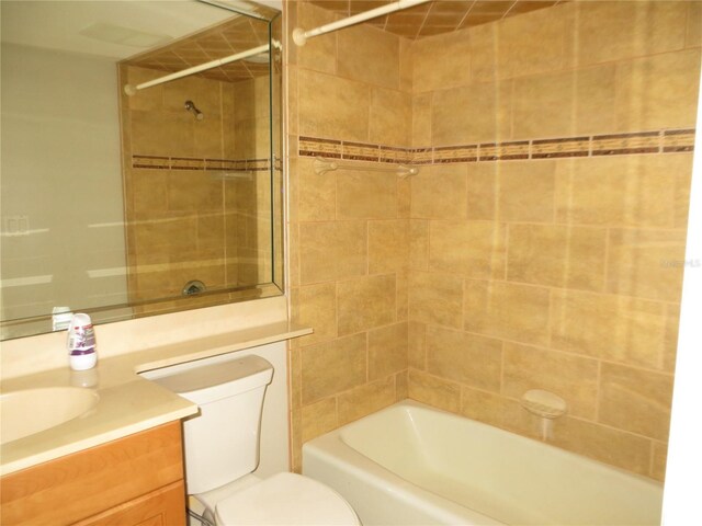 full bathroom featuring vanity, toilet, and tiled shower / bath combo