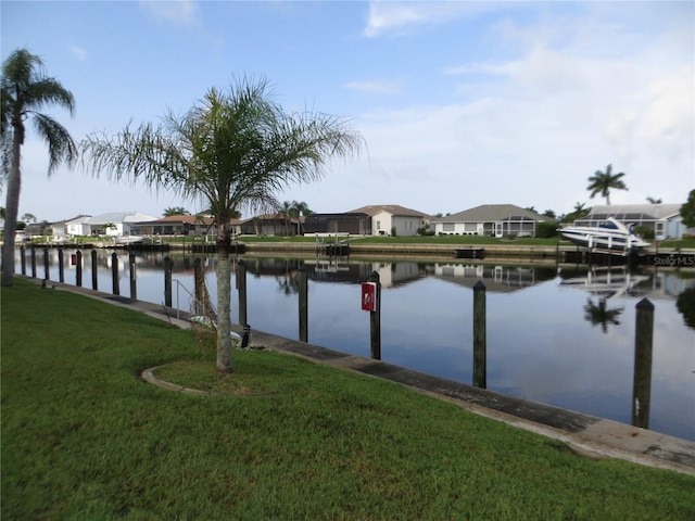 view of dock featuring a yard and a water view