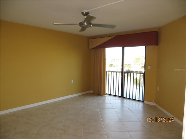 unfurnished room featuring ceiling fan and light tile patterned flooring