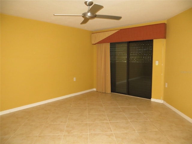 spare room featuring tile patterned floors and ceiling fan