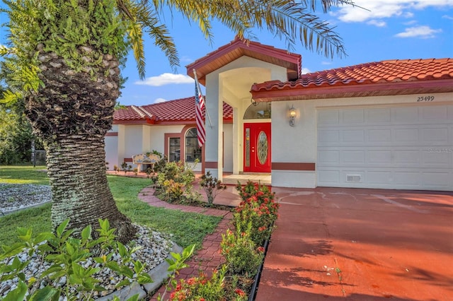 mediterranean / spanish home with a garage