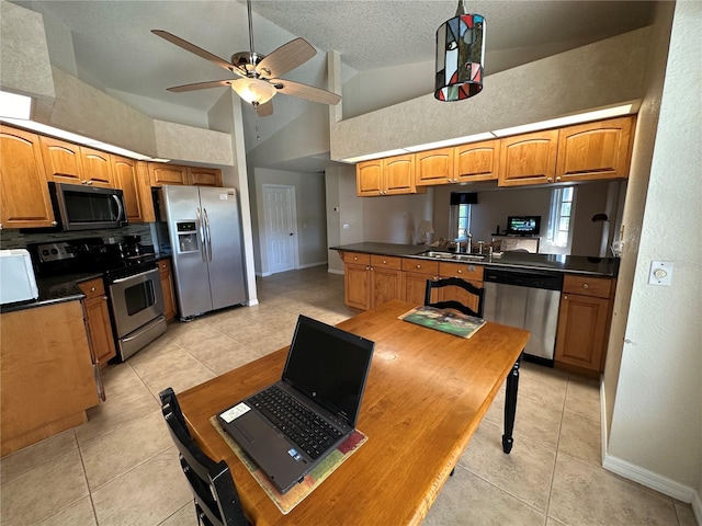 kitchen featuring light tile patterned floors, stainless steel appliances, sink, high vaulted ceiling, and ceiling fan