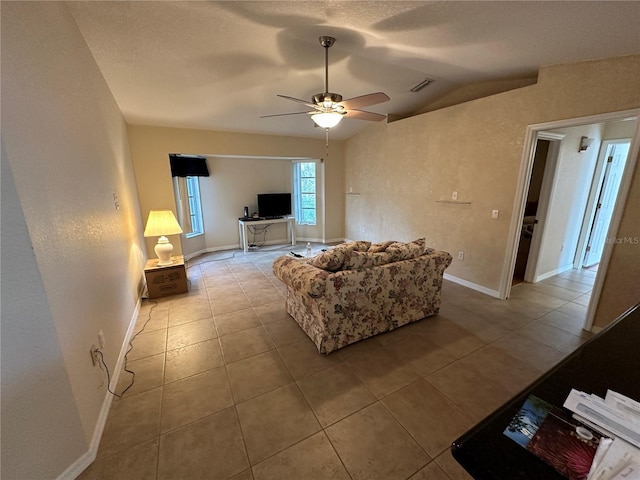 tiled living room with lofted ceiling and ceiling fan