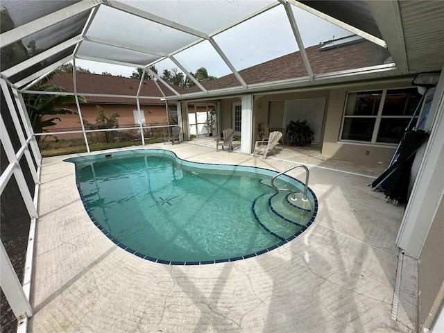 view of pool with a lanai and a patio