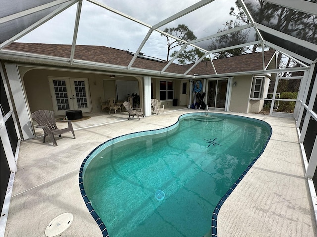 view of pool featuring french doors, a lanai, a patio area, and ceiling fan