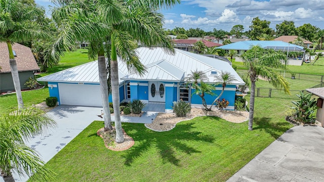 view of front of house featuring a garage, covered porch, and a front lawn