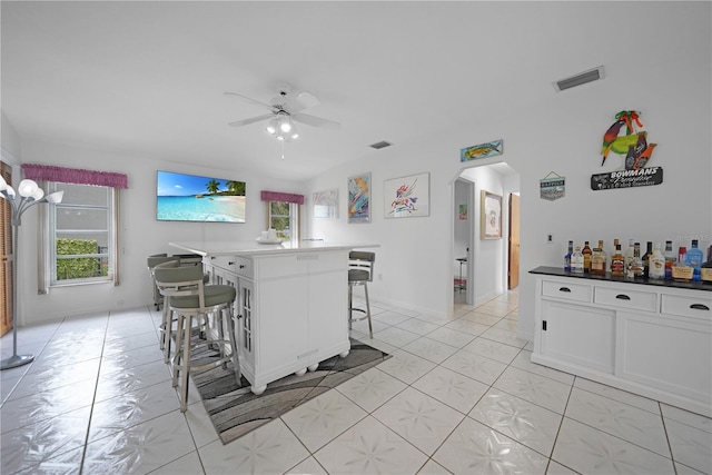 dining room with ceiling fan and bar