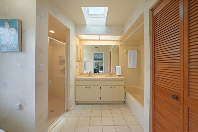 bathroom featuring vanity, tile patterned floors, plus walk in shower, and a skylight