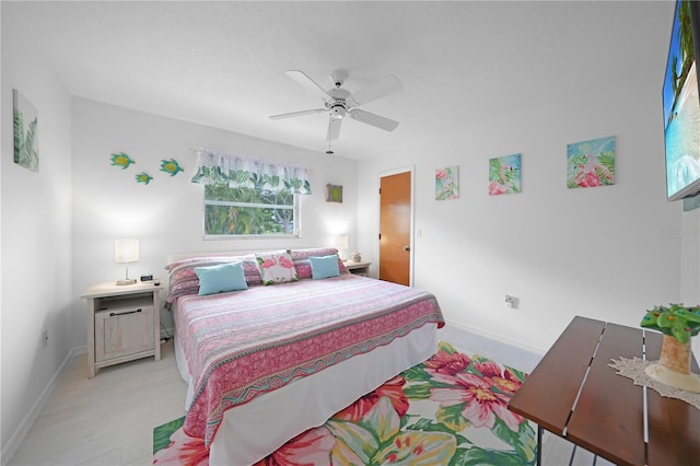 bedroom with light wood-type flooring and ceiling fan