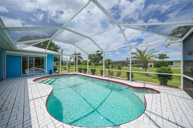 view of swimming pool featuring a lanai, a lawn, and a patio