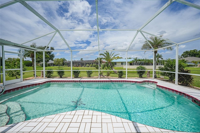 view of pool with a patio area and a lanai