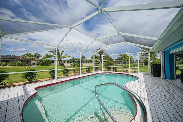 view of swimming pool with a lanai, a patio area, and a yard