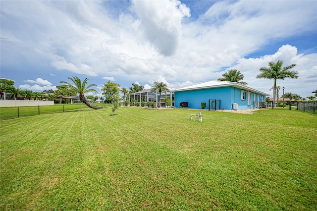 view of yard with glass enclosure