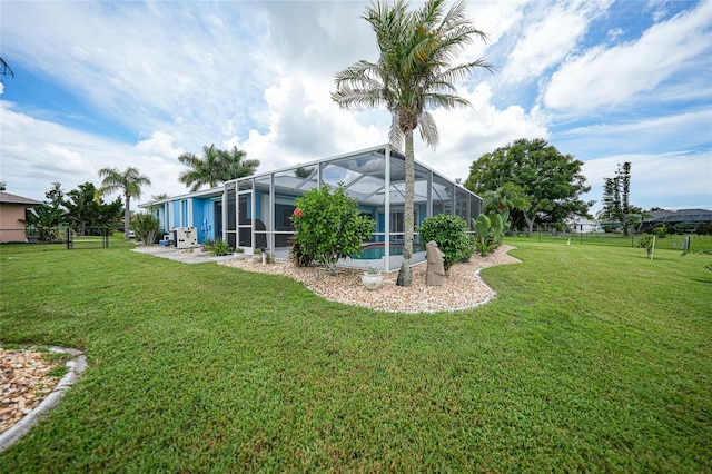 view of yard with glass enclosure