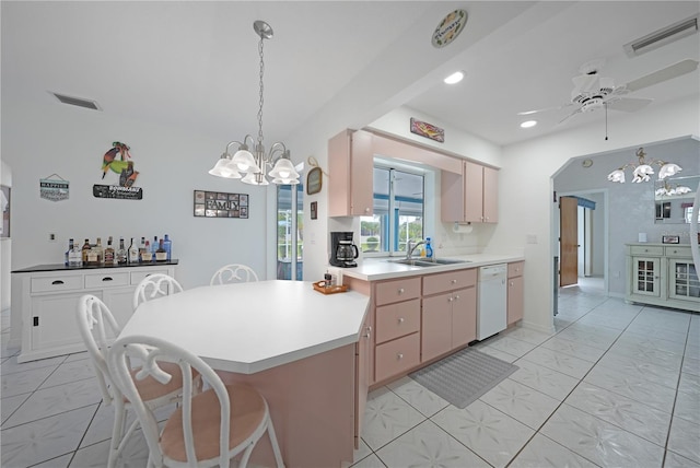 kitchen featuring white dishwasher, visible vents, light countertops, and a sink