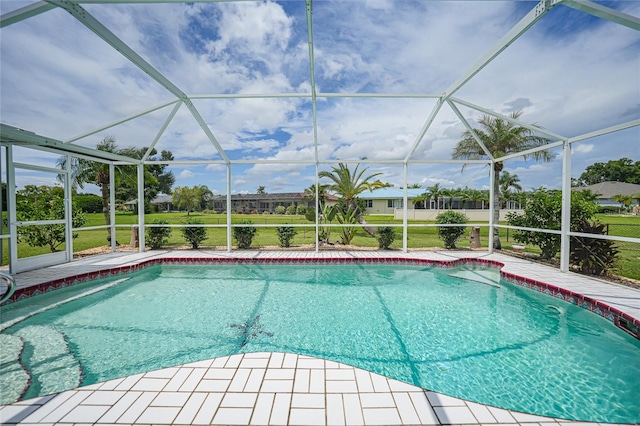 outdoor pool with glass enclosure and a patio