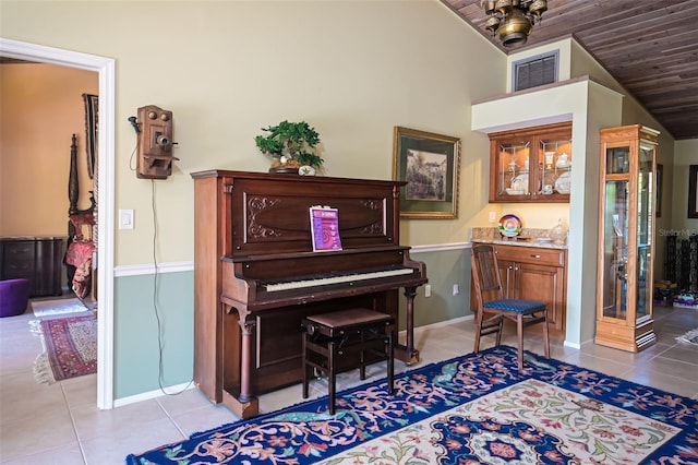 miscellaneous room featuring vaulted ceiling, light tile patterned floors, and wooden ceiling