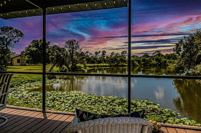 sunroom / solarium with a water view