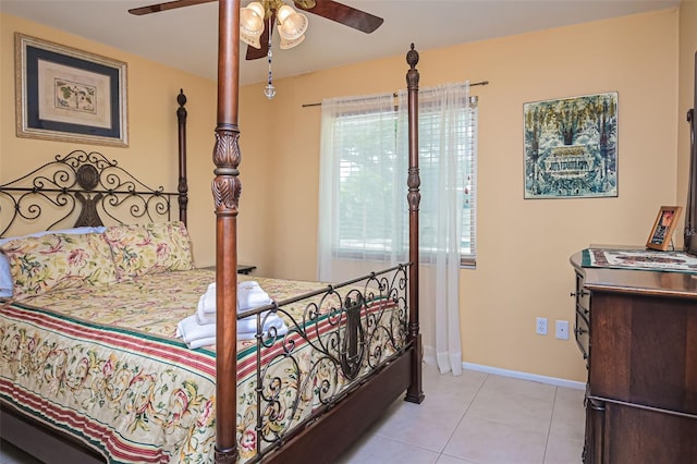 tiled bedroom featuring ceiling fan