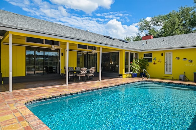 pool with a patio area and a ceiling fan