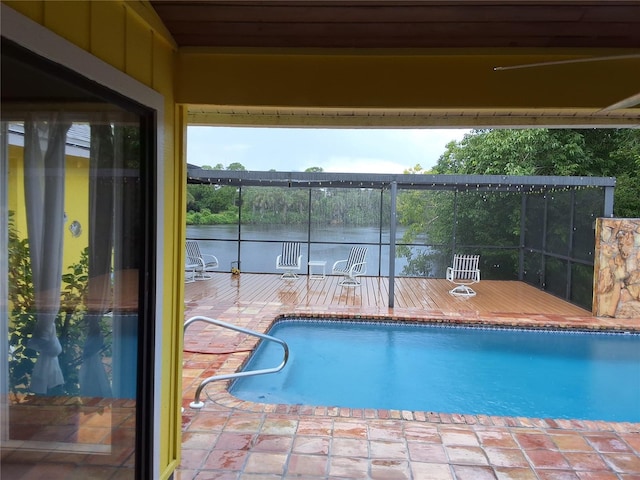 view of pool with a water view, a lanai, and a patio area