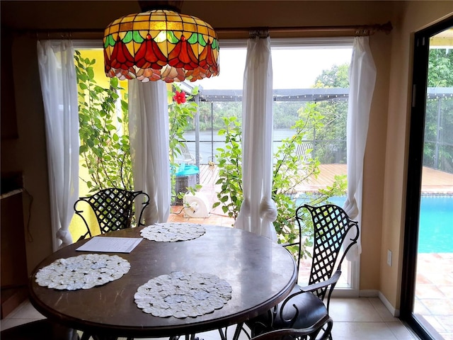 dining space with light tile patterned flooring and baseboards