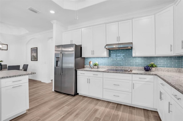 kitchen with decorative backsplash, wood finish floors, under cabinet range hood, and stainless steel fridge with ice dispenser