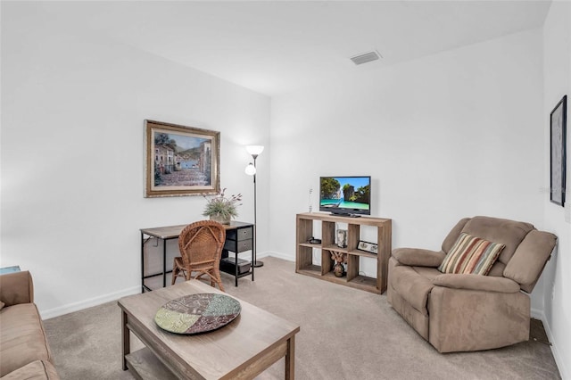 living area with visible vents, light carpet, and baseboards