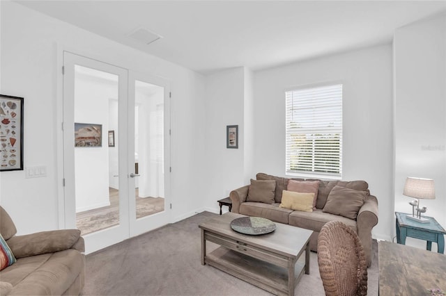 carpeted living area with french doors