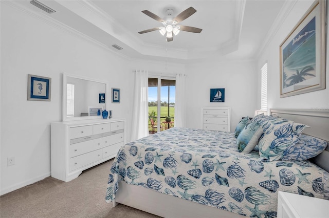 carpeted bedroom with access to outside, a raised ceiling, visible vents, and multiple windows