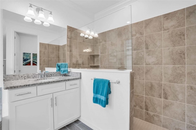 full bath featuring ornamental molding, vanity, and walk in shower